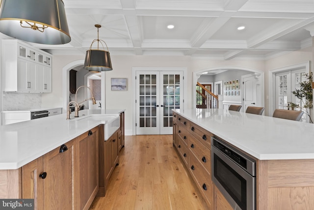 2740 Allen Glen Dr, Mechanicsburg, PA 17055 - kitchen with french doors, a spacious island, arched walkways, appliances with stainless steel finishes, and beamed ceiling