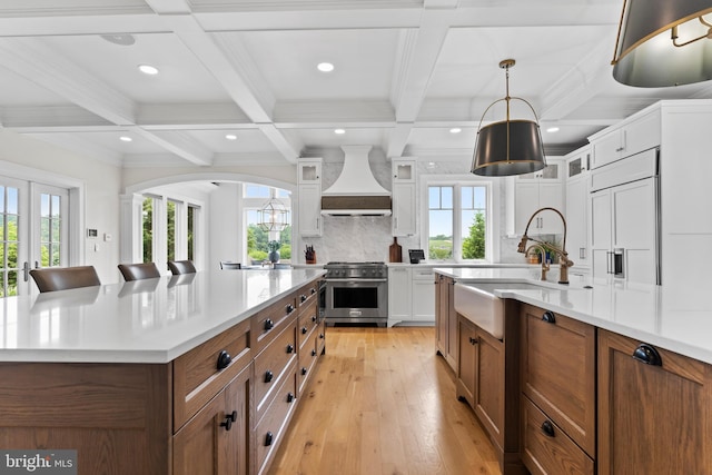 2740 Allen Glen Dr, Mechanicsburg, PA 17055 - kitchen with high end stainless steel range, custom range hood, healthy amount of natural light, light countertops, and beam ceiling
