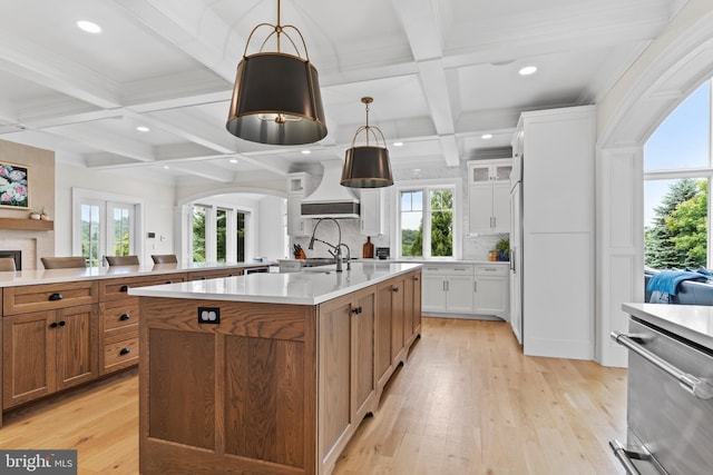 2740 Allen Glen Dr, Mechanicsburg, PA 17055 - kitchen with coffered ceiling, a spacious island, brown cabinets, beam ceiling, and premium range hood