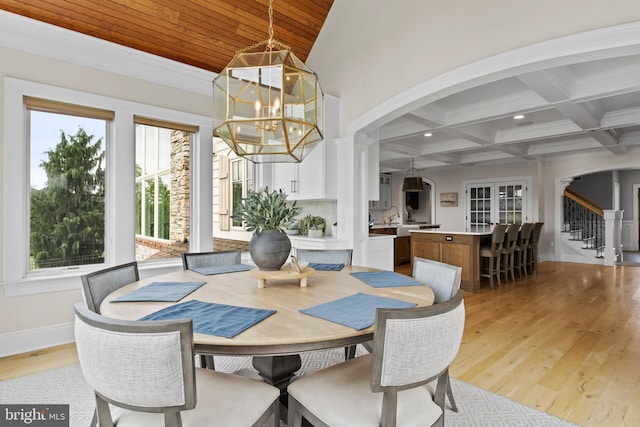 2740 Allen Glen Dr, Mechanicsburg, PA 17055 - dining area with arched walkways, a chandelier, light wood-style floors, stairs, and beamed ceiling