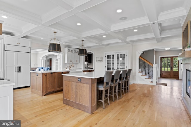 2740 Allen Glen Dr, Mechanicsburg, PA 17055 - kitchen featuring french doors, a large island, light wood finished floors, coffered ceiling, and beam ceiling