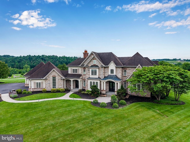 2740 Allen Glen Dr, Mechanicsburg, PA 17055 - view of front of house with stone siding, a chimney, a standing seam roof, and a front lawn
