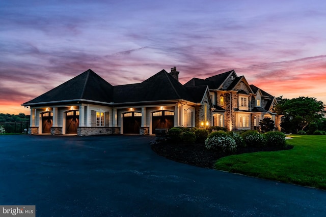 2740 Allen Glen Dr, Mechanicsburg, PA 17055 - view of front of house featuring stone siding, a chimney, an attached garage, a lawn, and driveway