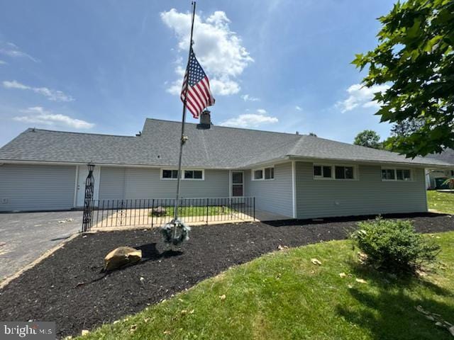 283 Snowball Dr, Levittown, PA 19056 - view of home's exterior featuring a garage and asphalt driveway
