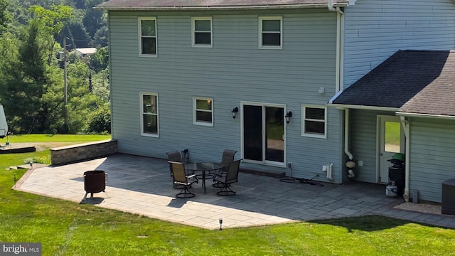 93 W Center St, Glen Rock, PA 17327 - rear view of house featuring a lawn, a patio area, and roof with shingles