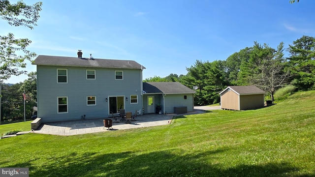 93 W Center St, Glen Rock, PA 17327 - back of house with a patio, a lawn, a storage unit, and a chimney