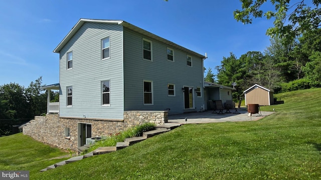 93 W Center St, Glen Rock, PA 17327 - back of property featuring a patio area, a yard, stone siding, and an outbuilding