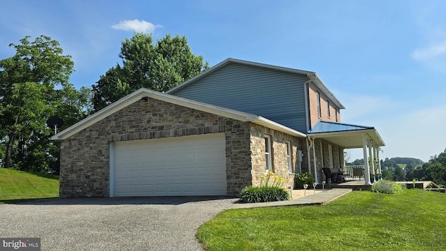93 W Center St, Glen Rock, PA 17327 - view of front facade featuring stone siding, a front yard, an attached garage, and asphalt driveway