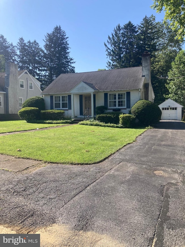 8 Stanton Ave, West Chester, PA 19382 - single story home featuring a chimney, a detached garage, an outdoor structure, a front yard, and driveway