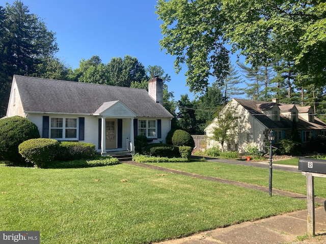 8 Stanton Ave, West Chester, PA 19382 - view of front of property with a chimney, a front yard, and stucco siding