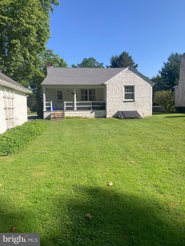 8 Stanton Ave, West Chester, PA 19382 - rear view of house with a lawn, covered porch, and a chimney