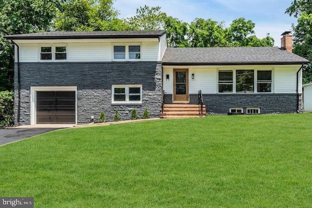 1528 Stuyvesant Ave, Trenton, NJ 08618 - split level home with stone siding, a front lawn, a garage, asphalt driveway, and a chimney