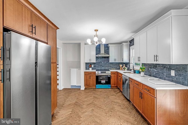 1528 Stuyvesant Ave, Trenton, NJ 08618 - kitchen featuring appliances with stainless steel finishes, wall chimney exhaust hood, tasteful backsplash, light countertops, and a chandelier