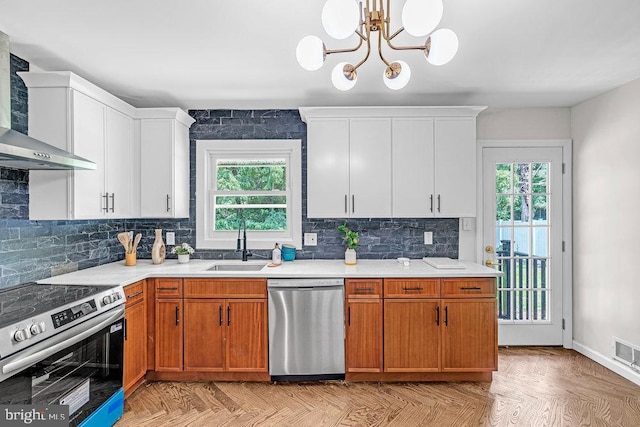 1528 Stuyvesant Ave, Trenton, NJ 08618 - kitchen featuring stainless steel appliances, wall chimney range hood, healthy amount of natural light, and light countertops