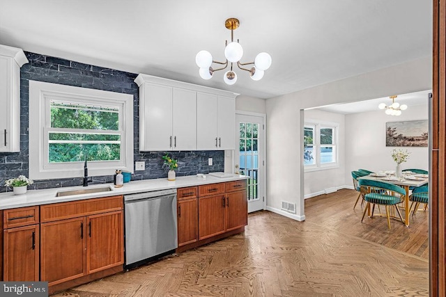 1528 Stuyvesant Ave, Trenton, NJ 08618 - kitchen with dishwasher, a chandelier, light countertops, backsplash, and brown cabinets