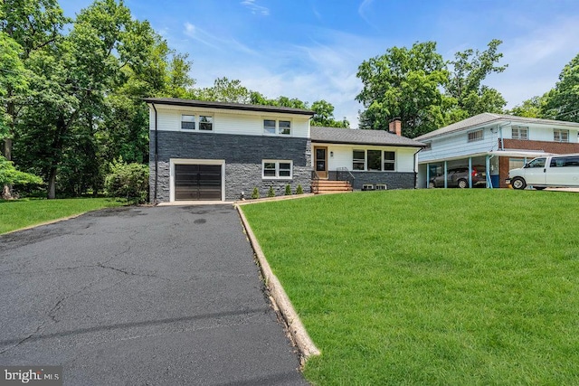 1528 Stuyvesant Ave, Trenton, NJ 08618 - split level home featuring stone siding, an attached garage, asphalt driveway, a front yard, and a chimney
