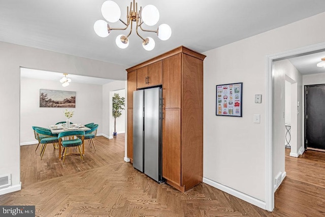 1528 Stuyvesant Ave, Trenton, NJ 08618 - kitchen with freestanding refrigerator, a chandelier, and brown cabinets