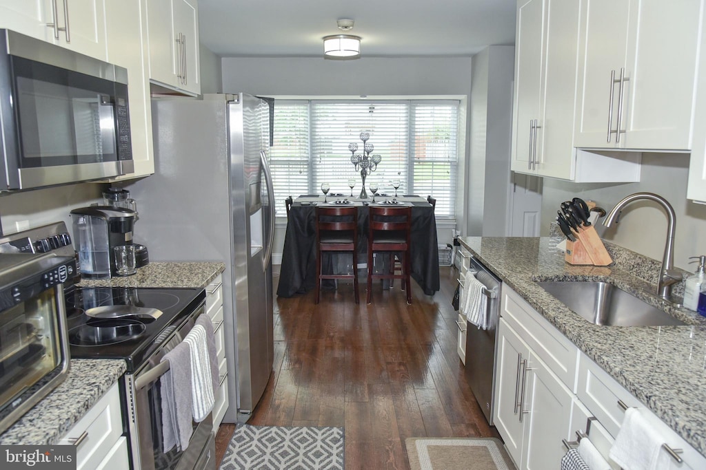 1510 Karen Blvd, District Heights, MD 20747 - kitchen featuring appliances with stainless steel finishes, dark wood finished floors, white cabinets, and light stone counters