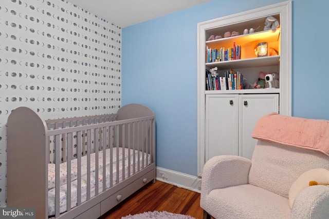16 E Abington Ave, Philadelphia, PA 19118 - bedroom featuring wood finished floors and a nursery area