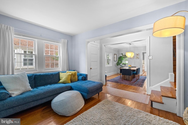 16 E Abington Ave, Philadelphia, PA 19118 - living area with healthy amount of natural light, wood finished floors, stairway, and a chandelier