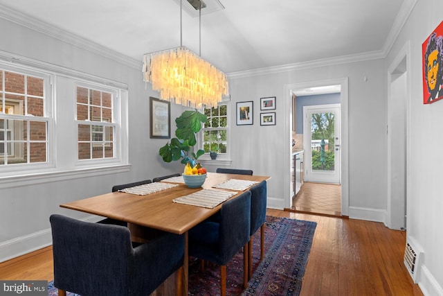16 E Abington Ave, Philadelphia, PA 19118 - dining space with wood-type flooring, a chandelier, and crown molding