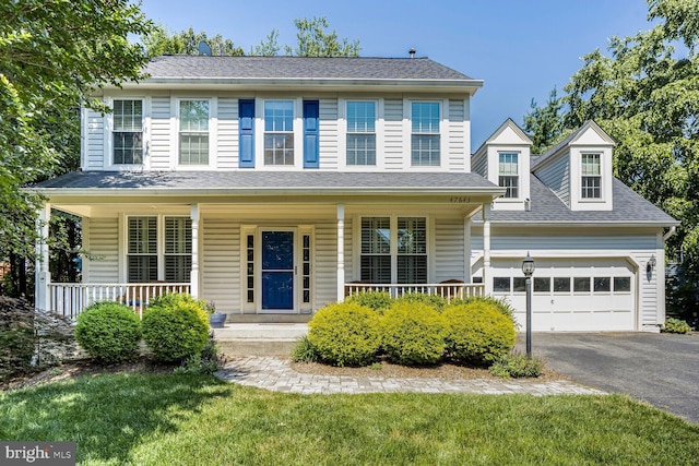 47643 Rhyolite Pl, Sterling, VA 20165 - view of front of house with driveway, a garage, covered porch, and a front yard