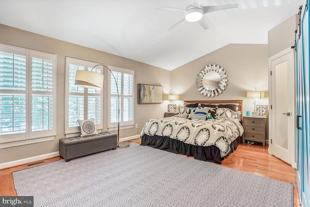 47643 Rhyolite Pl, Sterling, VA 20165 - bedroom featuring wood finished floors, a barn door, lofted ceiling, and ceiling fan
