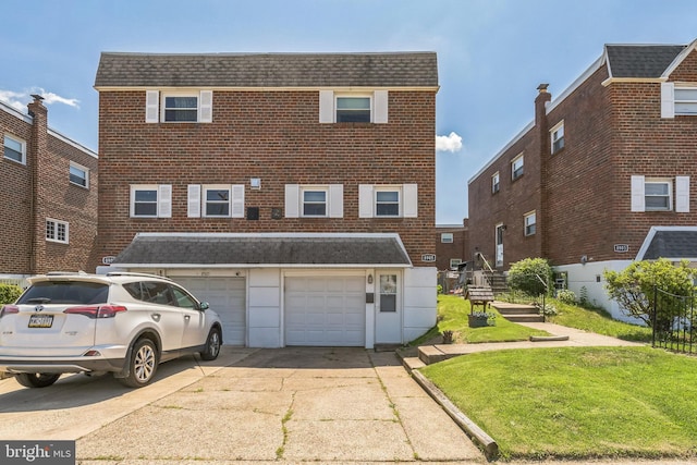 8905 Dewees St, Philadelphia, PA 19152 - view of front of home featuring concrete driveway, brick siding, roof with shingles, and a front lawn