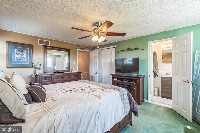 8905 Dewees St, Philadelphia, PA 19152 - carpeted bedroom featuring a textured ceiling, a closet, a ceiling fan, and connected bathroom