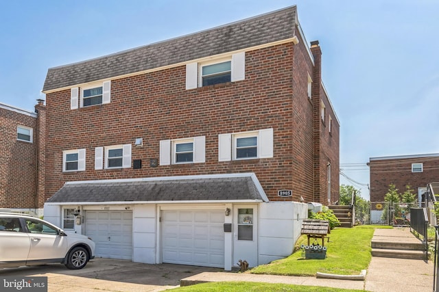8905 Dewees St, Philadelphia, PA 19152 - view of front facade with driveway, an attached garage, and brick siding