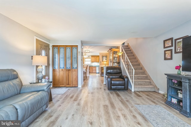 8905 Dewees St, Philadelphia, PA 19152 - living area featuring light wood-style floors and stairway