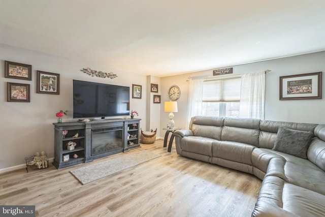 8905 Dewees St, Philadelphia, PA 19152 - living room featuring wood finished floors and a glass covered fireplace