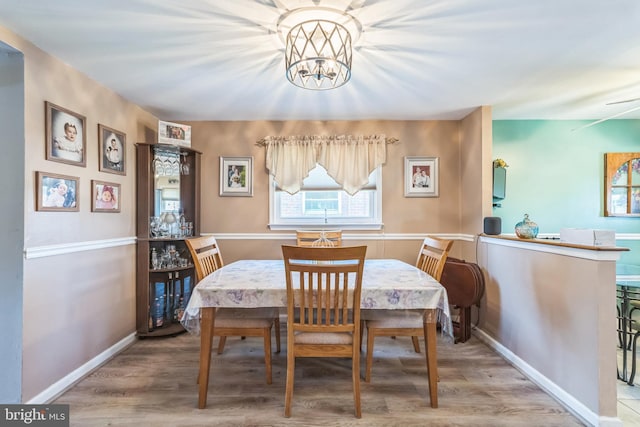 8905 Dewees St, Philadelphia, PA 19152 - dining room featuring a chandelier and wood finished floors