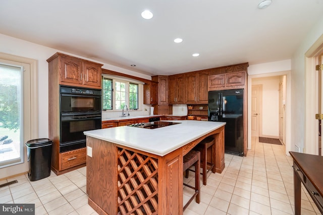 14 Quail Ridge Dr, Reading, PA 19607 - kitchen with black appliances, light tile patterned flooring, light countertops, a center island, and recessed lighting