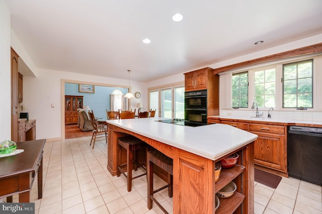 14 Quail Ridge Dr, Reading, PA 19607 - kitchen featuring black appliances, open shelves, brown cabinets, light countertops, and a kitchen island