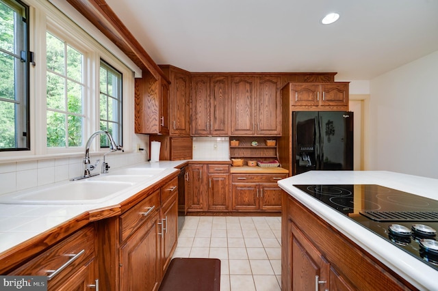 14 Quail Ridge Dr, Reading, PA 19607 - kitchen with black appliances, brown cabinetry, decorative backsplash, light tile patterned flooring, and recessed lighting