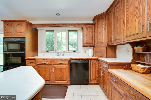 14 Quail Ridge Dr, Reading, PA 19607 - kitchen with black appliances, brown cabinetry, decorative backsplash, and tile counters