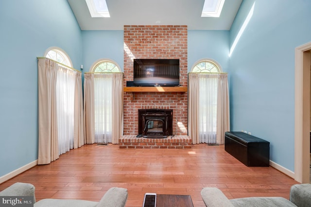 14 Quail Ridge Dr, Reading, PA 19607 - living room featuring a skylight, hardwood / wood-style flooring, a wood stove, and a high ceiling