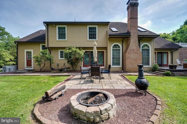 14 Quail Ridge Dr, Reading, PA 19607 - rear view of house featuring a fire pit, a lawn, a patio, and a chimney