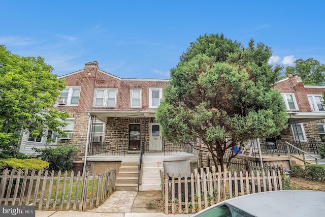 4641 Fernhill Rd, Philadelphia, PA 19144 - townhome / multi-family property with a porch, a fenced front yard, stone siding, and stairs