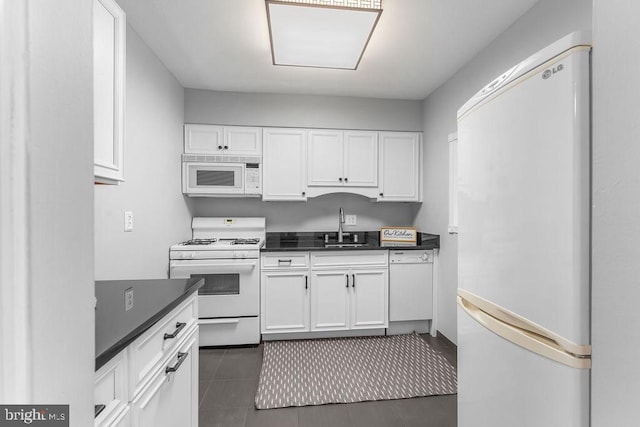 8308 Flower Ave Unit 403, Takoma Park, MD 20912 - kitchen featuring white appliances, white cabinets, and dark countertops