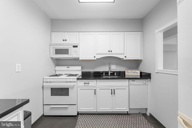 8308 Flower Ave Unit 403, Takoma Park, MD 20912 - kitchen with white appliances, dark tile patterned floors, white cabinets, and dark countertops