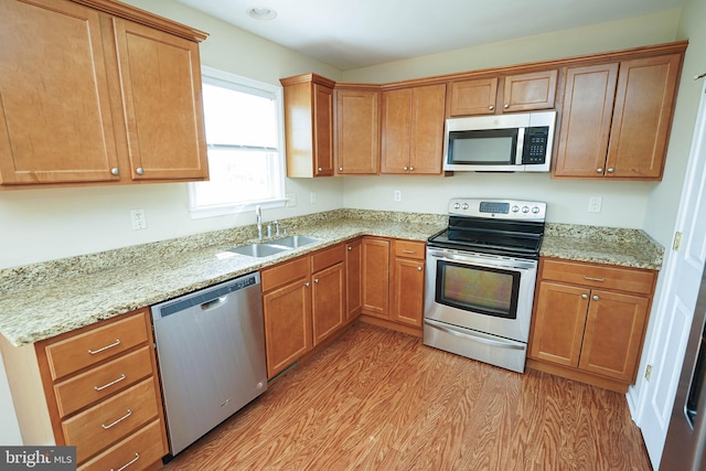 1322 Aspen Dr, Salisbury, MD 21804 - kitchen with appliances with stainless steel finishes, light wood-style floors, light stone counters, and brown cabinetry