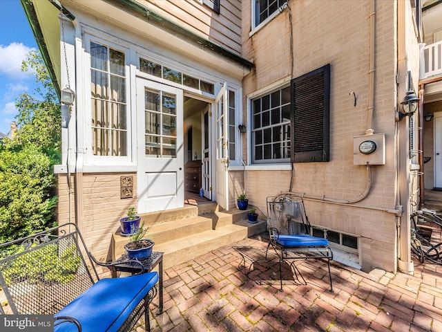 306 Grove Blvd, Frederick, MD 21701 - view of exterior entry featuring a patio and brick siding
