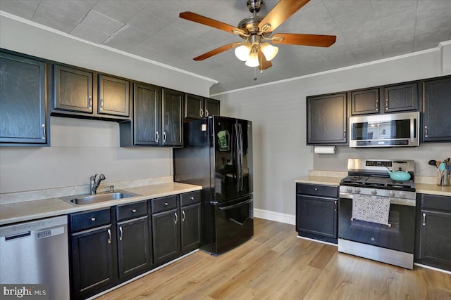 3314 Orchard Pl, Reading, PA 19605 - kitchen featuring appliances with stainless steel finishes, a ceiling fan, light countertops, light wood-style floors, and crown molding