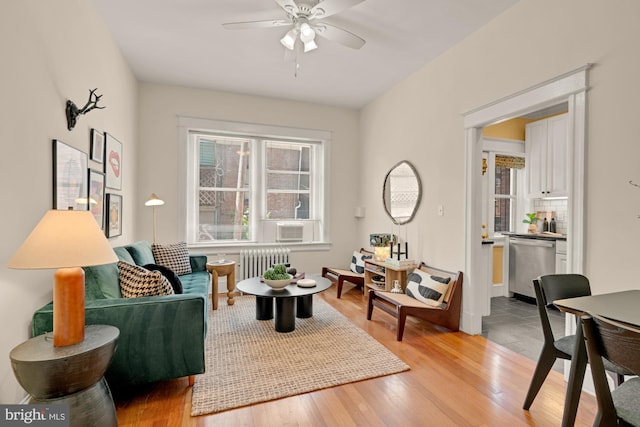 1833 S St NW Unit 2, Washington, DC 20009 - living room featuring radiator, ceiling fan, and light wood-style flooring