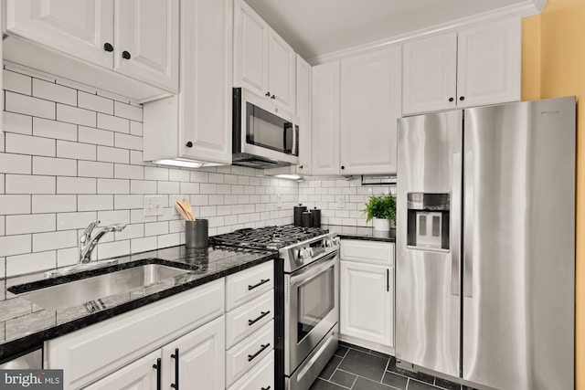 1833 S St NW Unit 2, Washington, DC 20009 - kitchen featuring appliances with stainless steel finishes, white cabinetry, dark tile patterned floors, and decorative backsplash