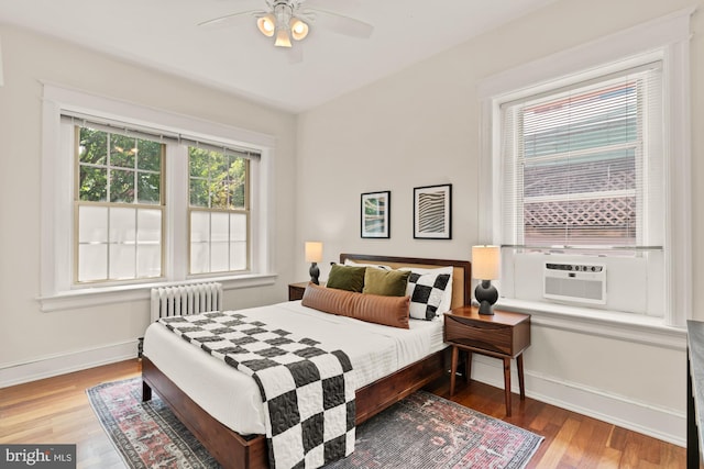 1833 S St NW Unit 2, Washington, DC 20009 - bedroom with radiator heating unit, wood finished floors, cooling unit, and a ceiling fan