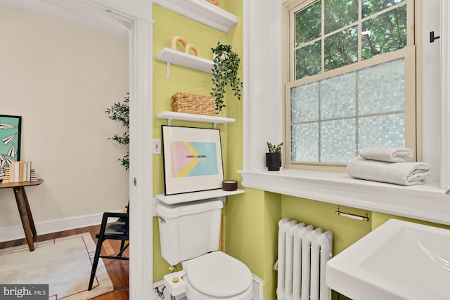 1833 S St NW Unit 2, Washington, DC 20009 - bathroom featuring radiator and wood finished floors