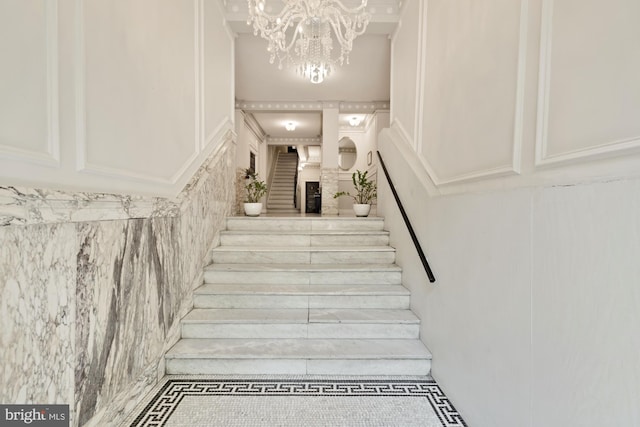 1833 S St NW Unit 2, Washington, DC 20009 - staircase with a decorative wall, tile patterned flooring, and a chandelier
